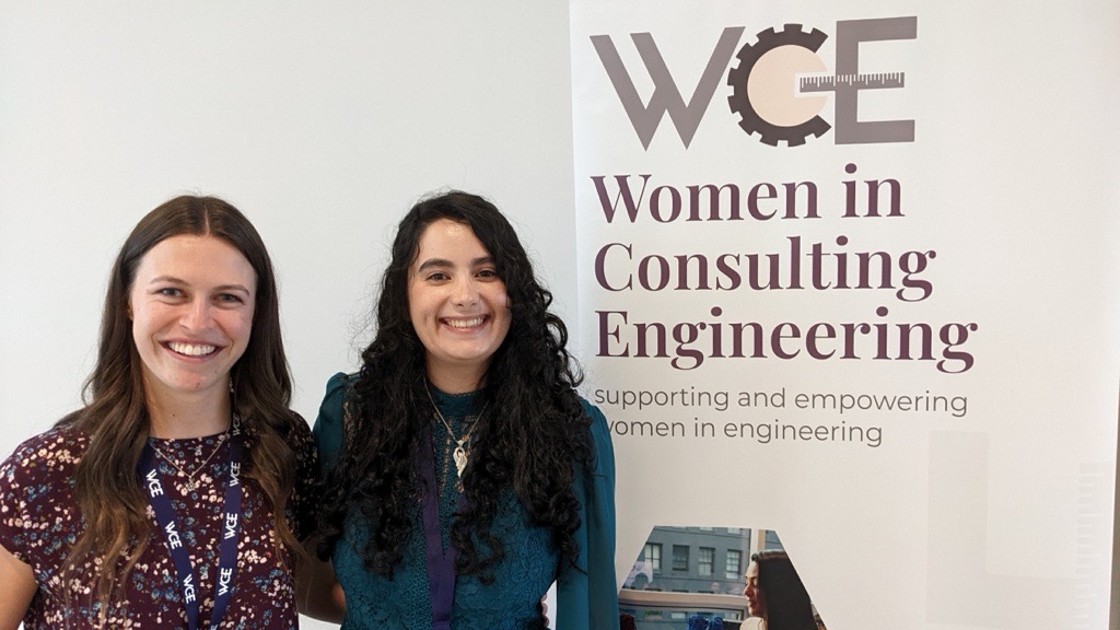 Image of Neda and a colleague standing in front of a Women in Consulting Engineering sign.