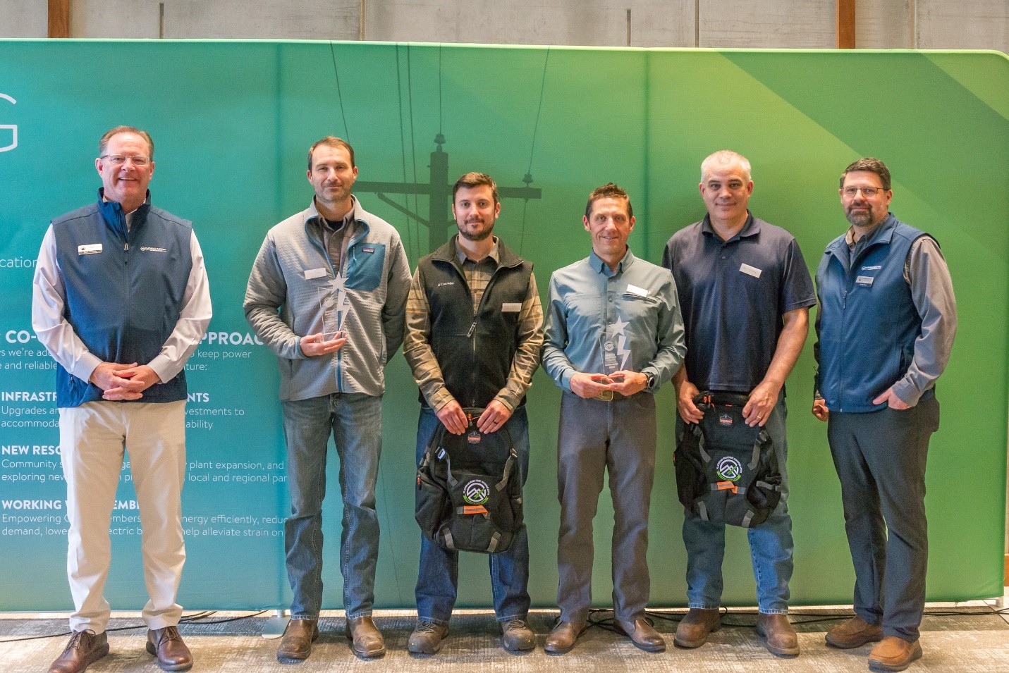 Image of six men standing against a backdrop. The six representatives from Weyerhaeuser and FEC.