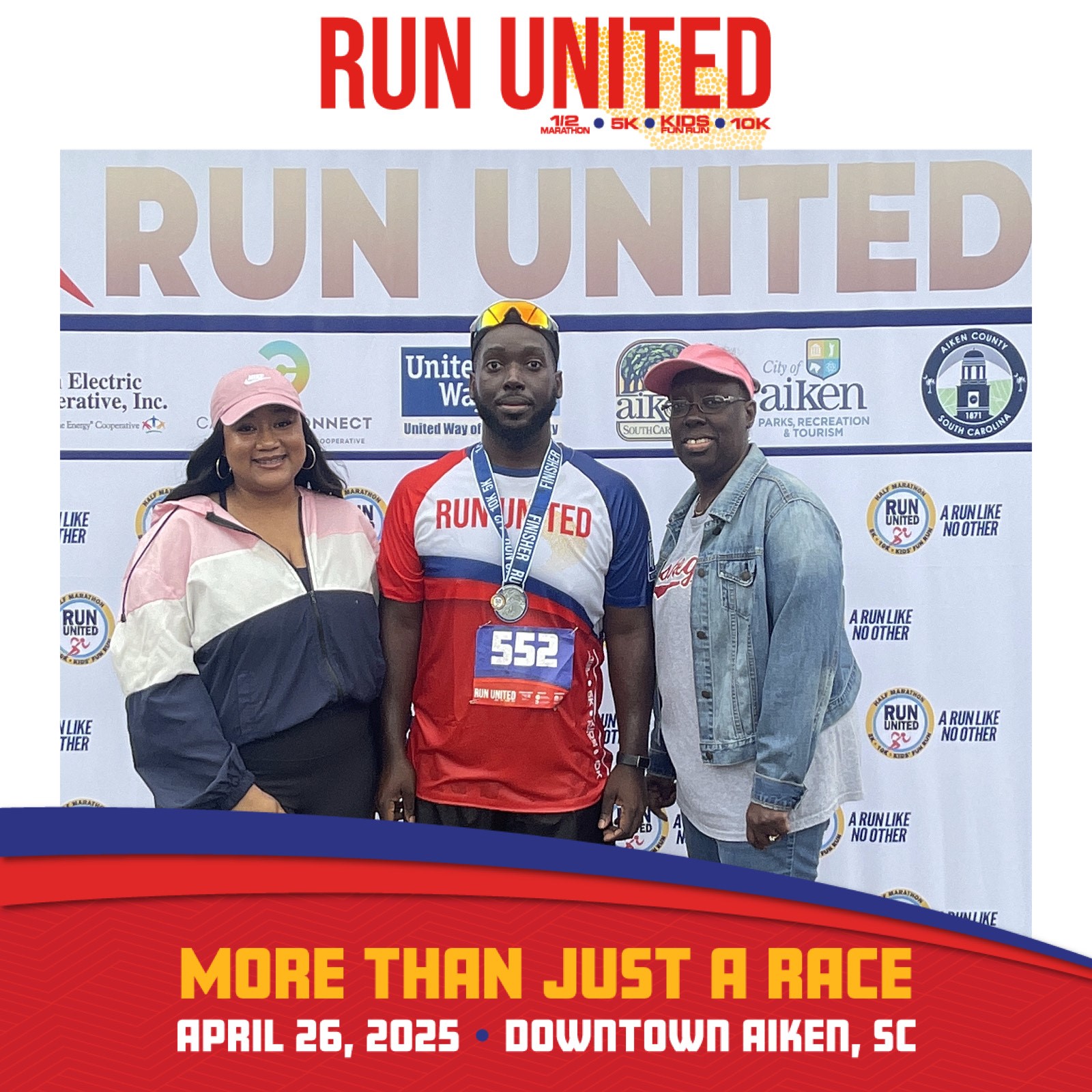 Image of Marquess James following a 10K race. He is wearing running gear and has his fiancee on the left side of the photo and his mother on the right side.